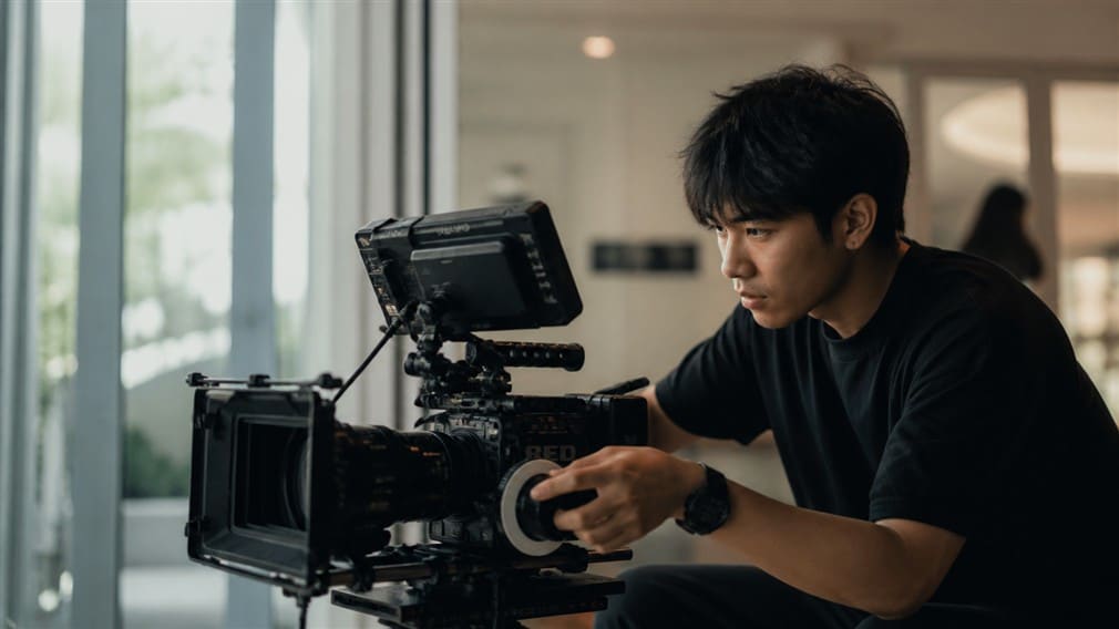 Camera operator and production crew on set in Thailand